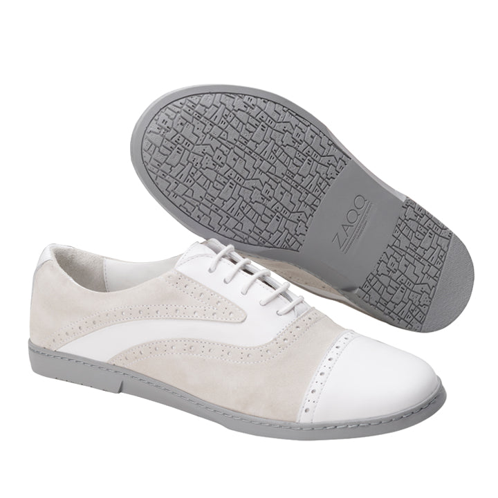 Wir präsentieren den „QENTLE White“ von ZAQQ: Diese stilvollen Herrenschuhe kombinieren Wildleder und Nappaleder in einem auffälligen hellbeigen und weißen Finish. Sie verfügen über ein elegantes Schnürdesign mit klassischem Flügelspitzenmuster. Die grauen Sohlen weisen ein strukturiertes geometrisches Muster auf und zeigen stolz den Markennamen ZAQQ. Damit sind sie ideal für diejenigen, die die QENTLE-Ästhetik schätzen.