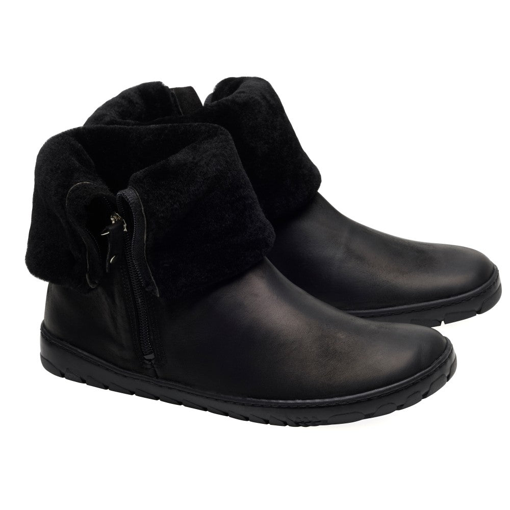 Der HUQ Black von ZAQQ ist ein Paar schwarze Stiefeletten aus weichem Veloursleder mit umgeschlagenen Bündchen und seitlichen Reißverschlüssen. Diese Stiefel bieten mit ihrer flachen Sohle und dem Nullabsatz-Design ein elegantes Erscheinungsbild und sind somit ideal für die Freizeit.