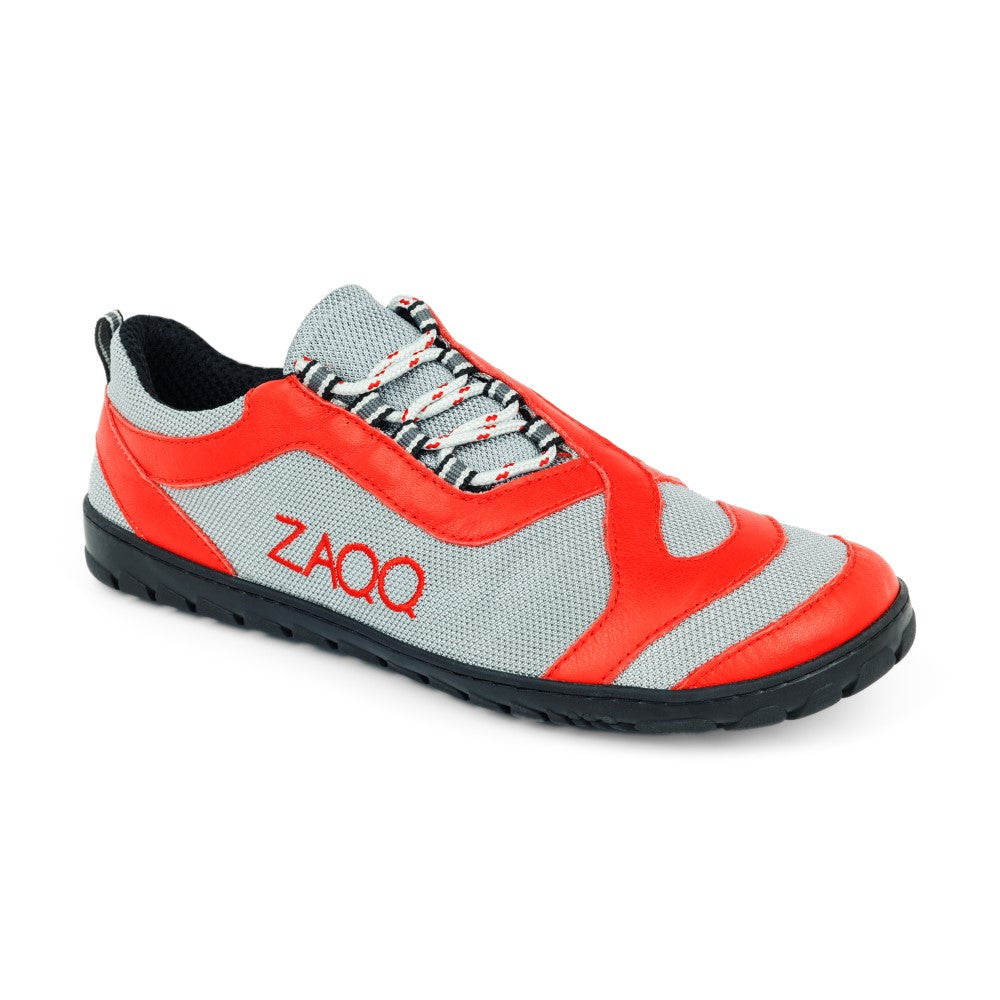 Der QUIQ Trail Lightred von ZAQQ ist ein eleganter, moderner Barfußschuh in Rot- und Grautönen mit schwarzer Sohle und bunten Schnürsenkeln. Er trägt stolz das Wort ZAQQ auf der Seite und hat ein Mesh-Design für außergewöhnliche Atmungsaktivität, was ihn zum idealen Begleiter für alle macht, die sowohl Stil als auch Komfort schätzen.